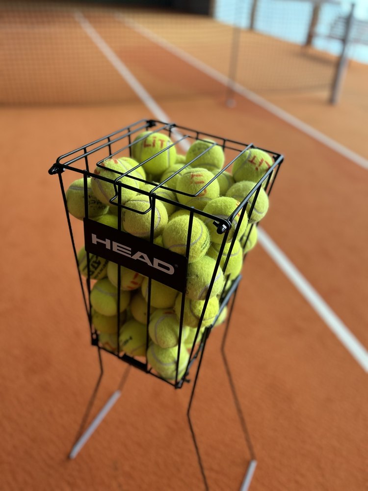 A basket of tennis balls ready for a private session